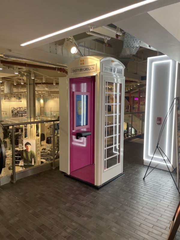 a pink telephone booth in a mall