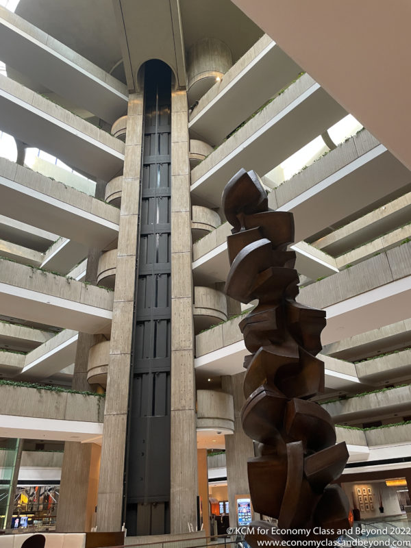 a tall metal sculpture in a building