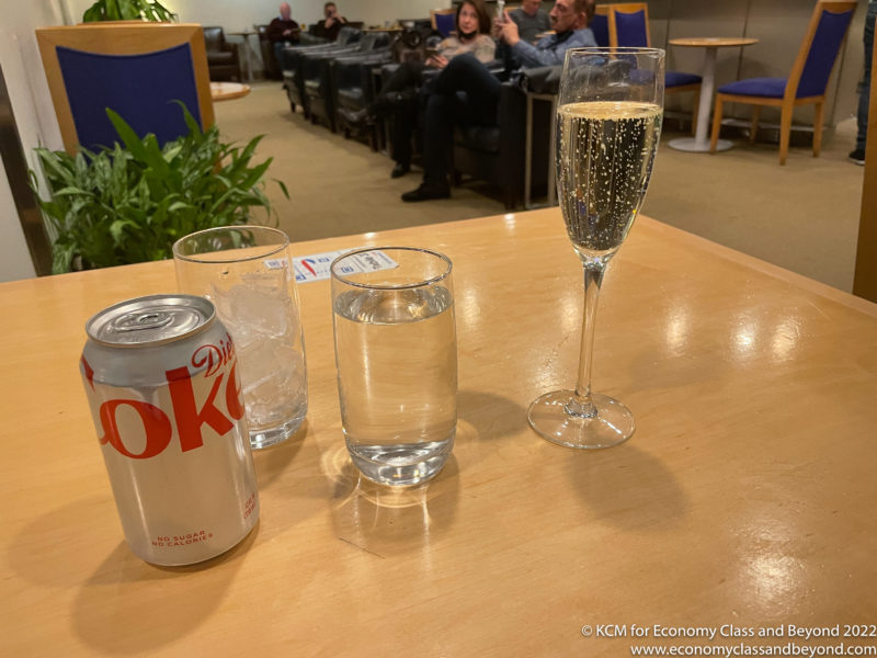 a group of glasses and a can of soda on a table