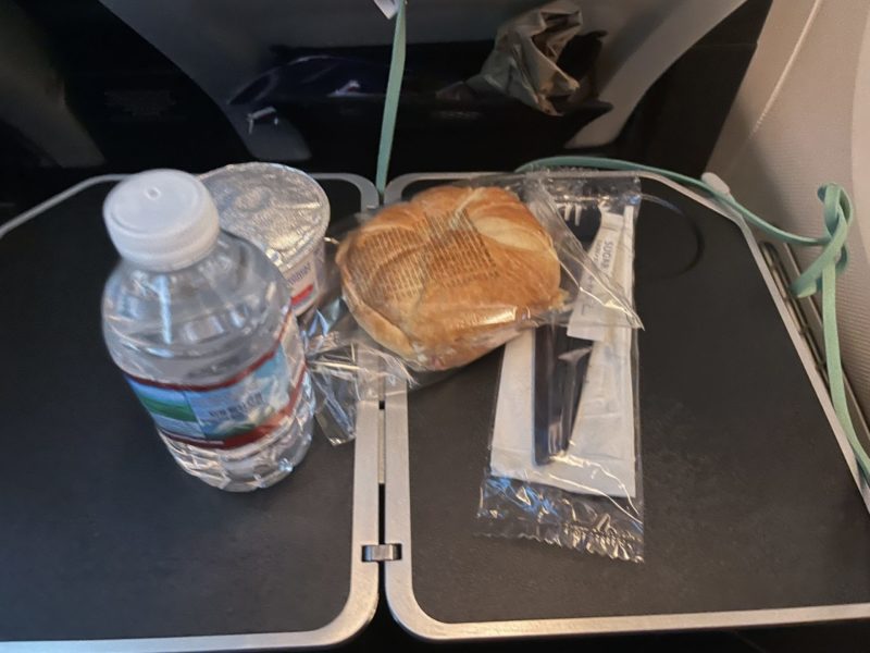a sandwich and water bottle on a table