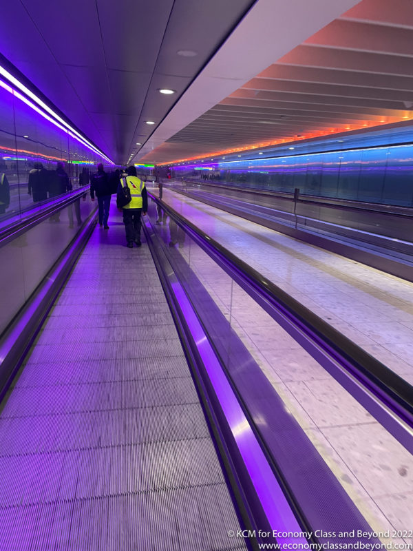 people walking on an escalator