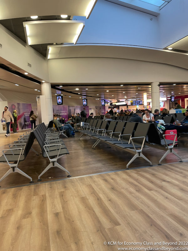 a group of people sitting in an airport terminal