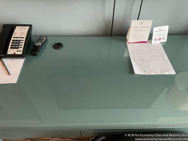a desk with a phone and papers on it