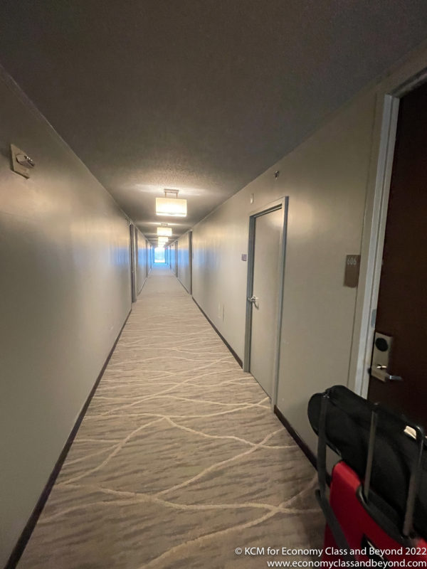 a hallway with a suitcase on the side