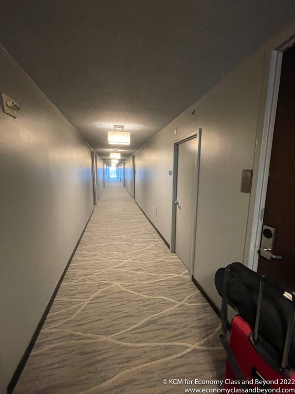 a hallway with a carpeted floor and a door