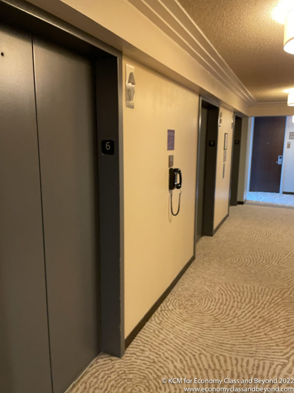 a hallway with two elevators