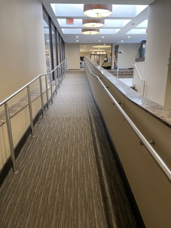 a hallway with a railing and a handrail
