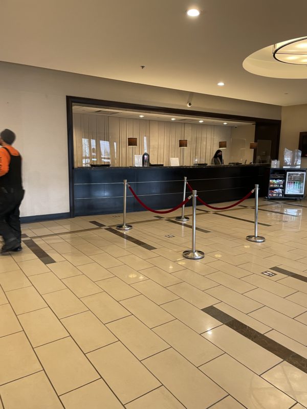 a room with a reception desk and a man walking