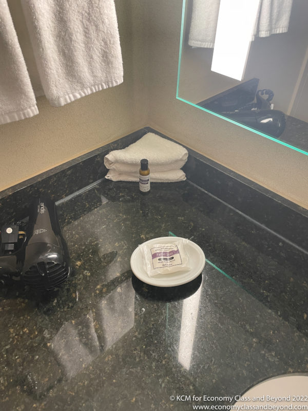 a bathroom counter with a towel and a blow dryer