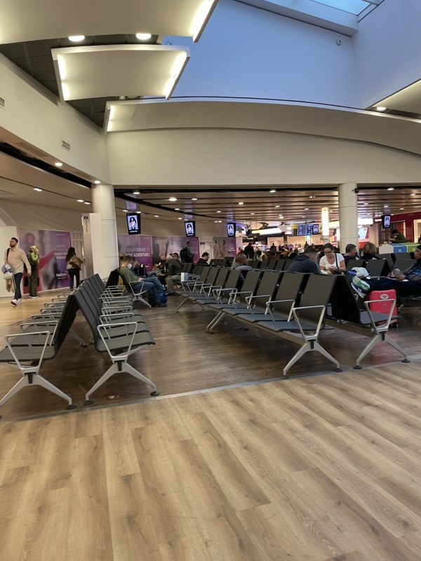 a group of people sitting in an airport terminal