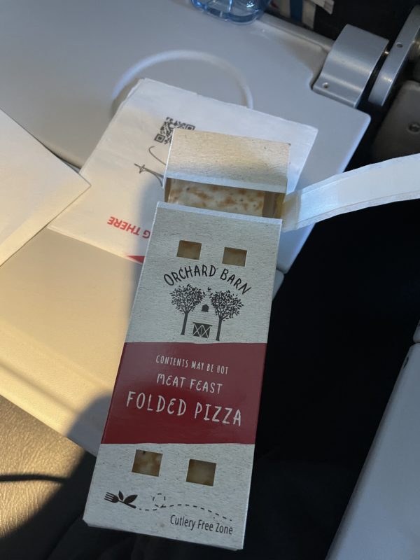 a box of pizza on a plane