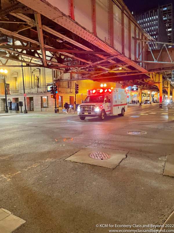 a ambulance on a street under a bridge
