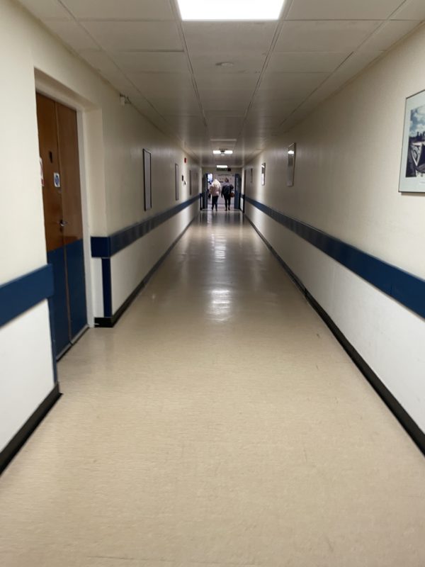 a hallway with people walking in the distance