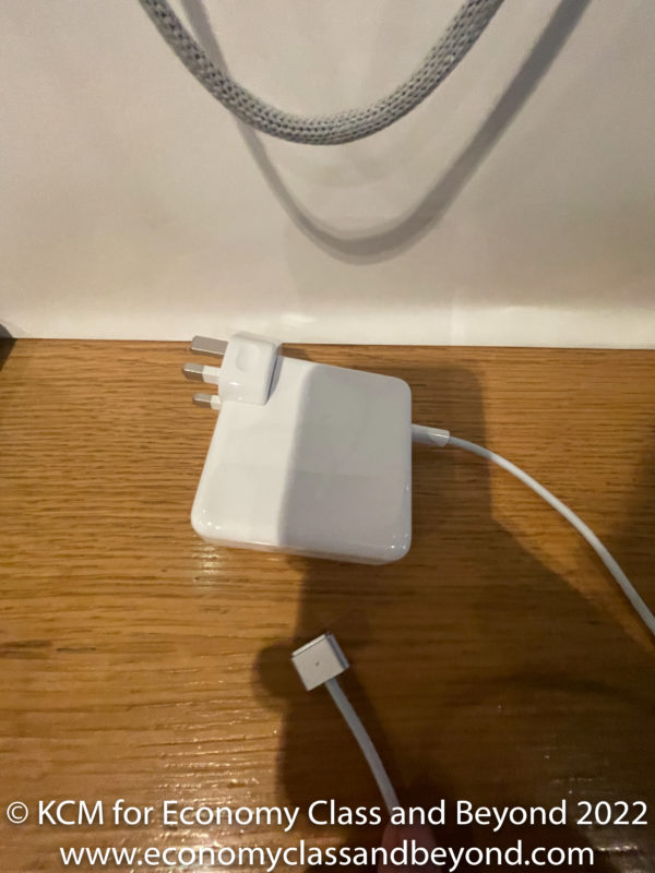 a white charger on a wood surface