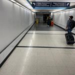 a man with luggage in a hallway