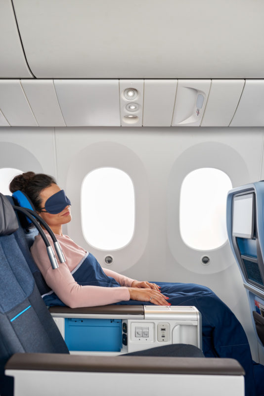a woman sleeping on an airplane