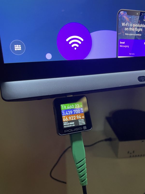 a computer monitor with a charger attached to it
