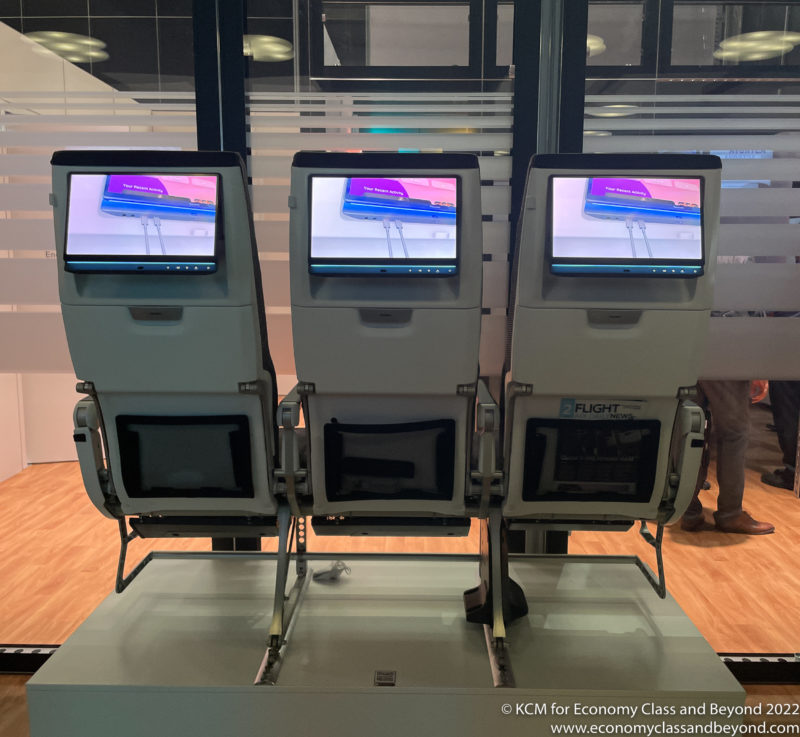 a row of seats with screens on each side