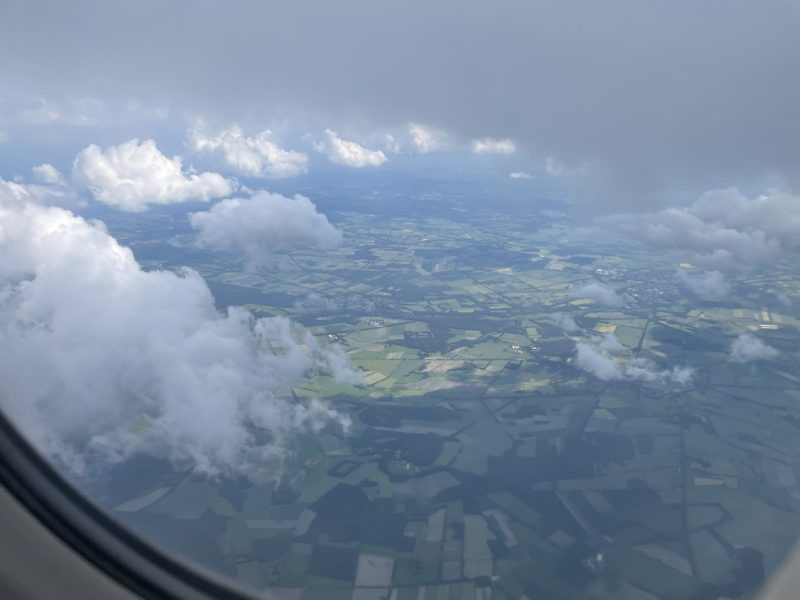 aerial view of clouds and land from an airplane window