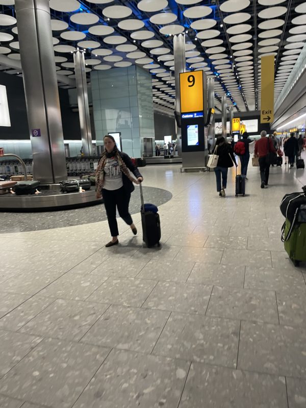 a woman pulling a suitcase in an airport