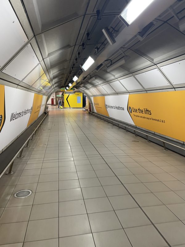a hallway with yellow and white signs