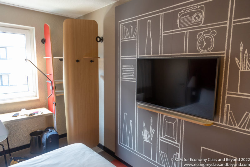 a room with a tv and a shelf