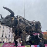a large metal bull with large wheels and a bull head