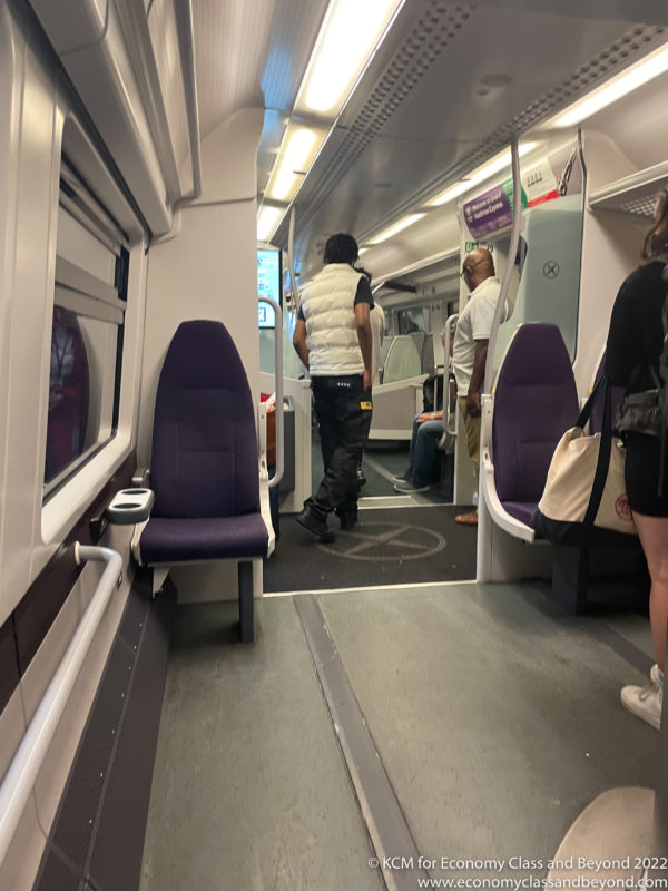 people inside a train with people standing in the door