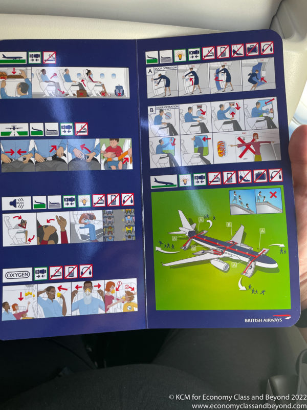 a hand holding an airplane instruction booklet