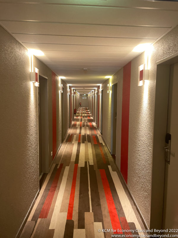 a long hallway with striped carpet