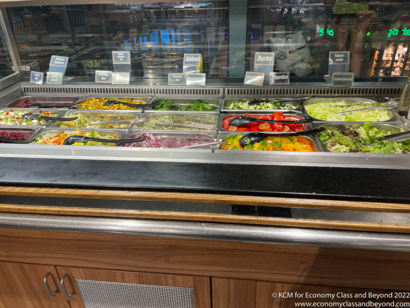 a salad bar with food in containers