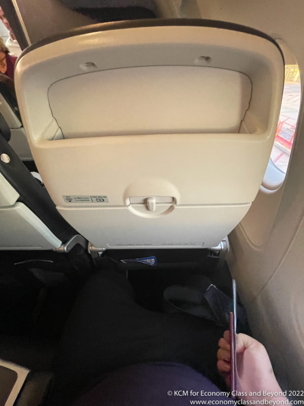 a person holding a pen in an airplane