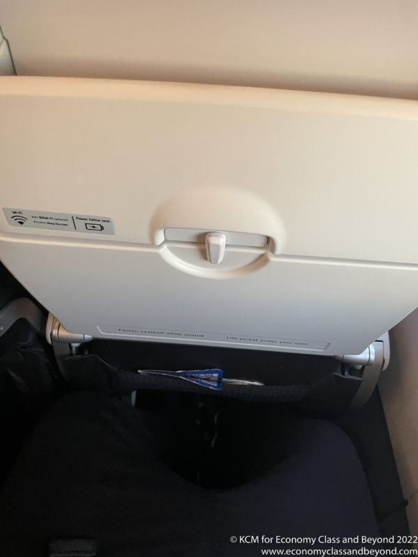 an overhead seat with a button on the side