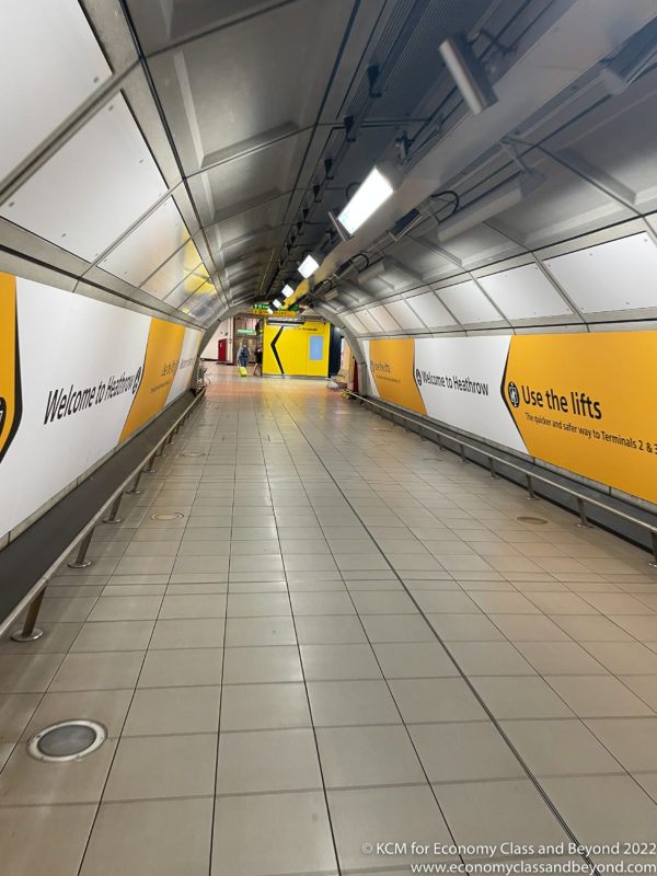 a walkway with yellow and white walls