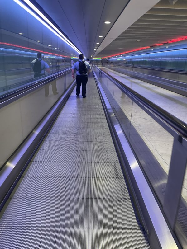 a man walking on an escalator