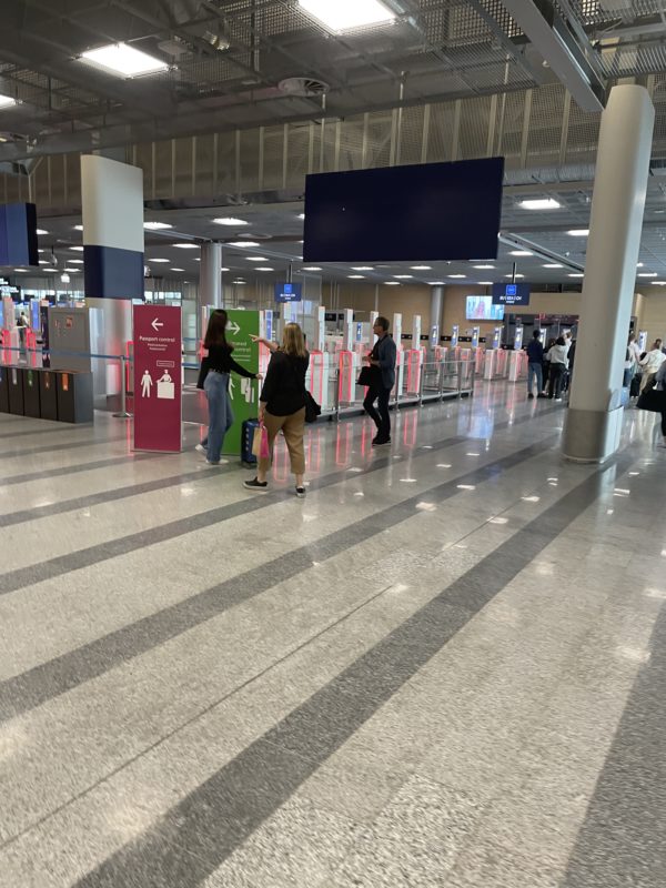people in a terminal with people standing in front of them