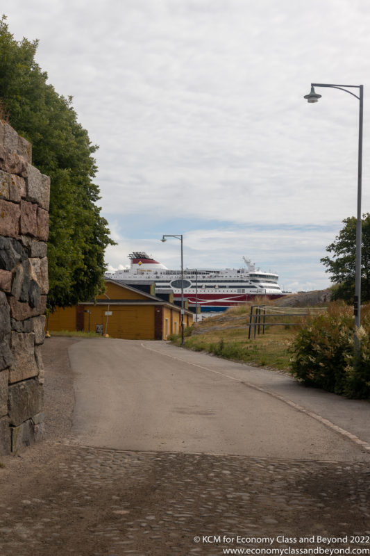 a road with a ship in the distance