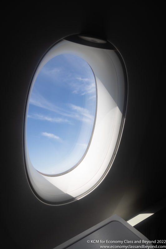 a window with a blue sky and clouds