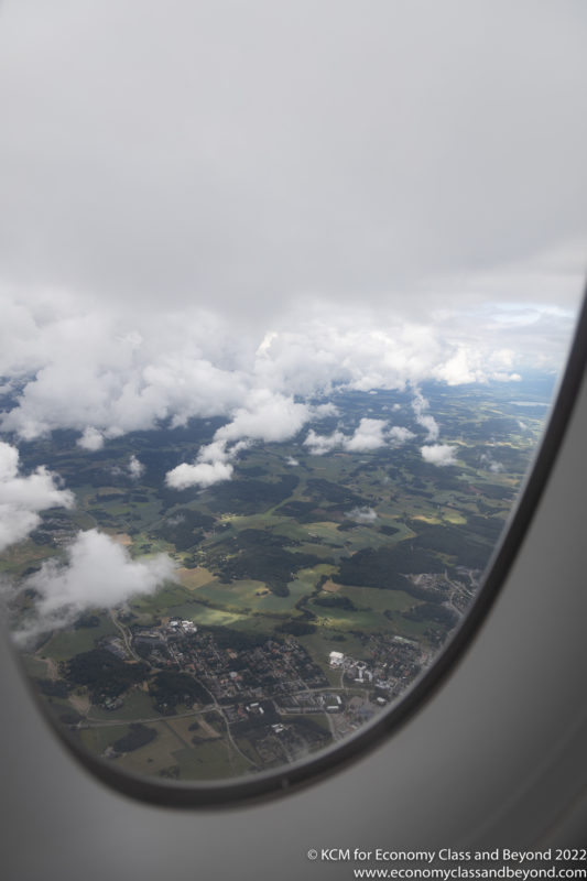 a view of clouds and land from an airplane window