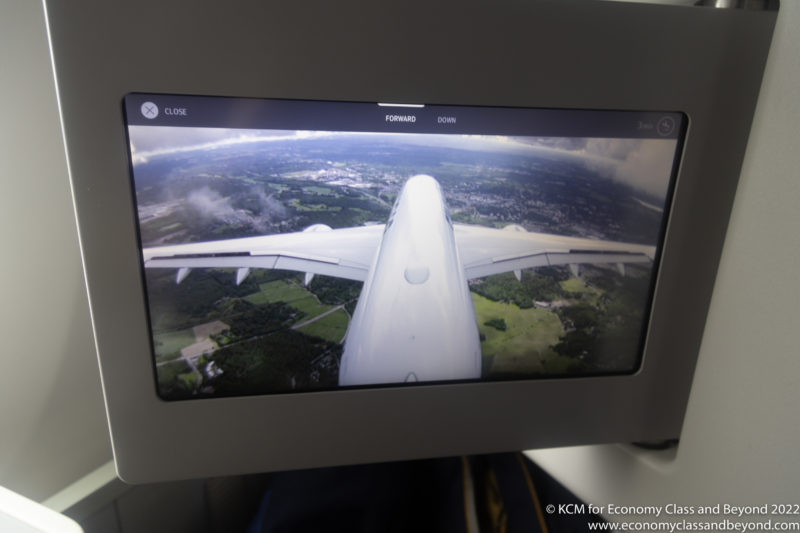 a screen with a plane flying in the sky