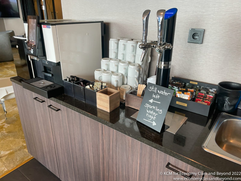 a coffee machine and a dispenser on a counter