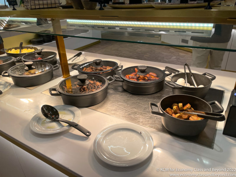 a buffet table with food in pots