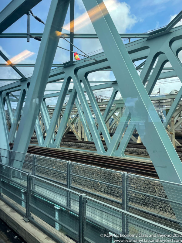 a train tracks under a bridge