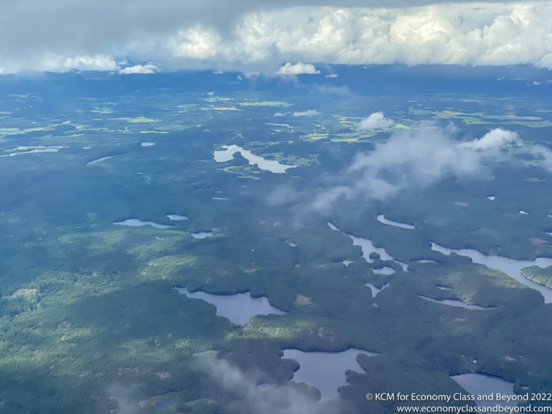 aerial view of a landscape with clouds and water