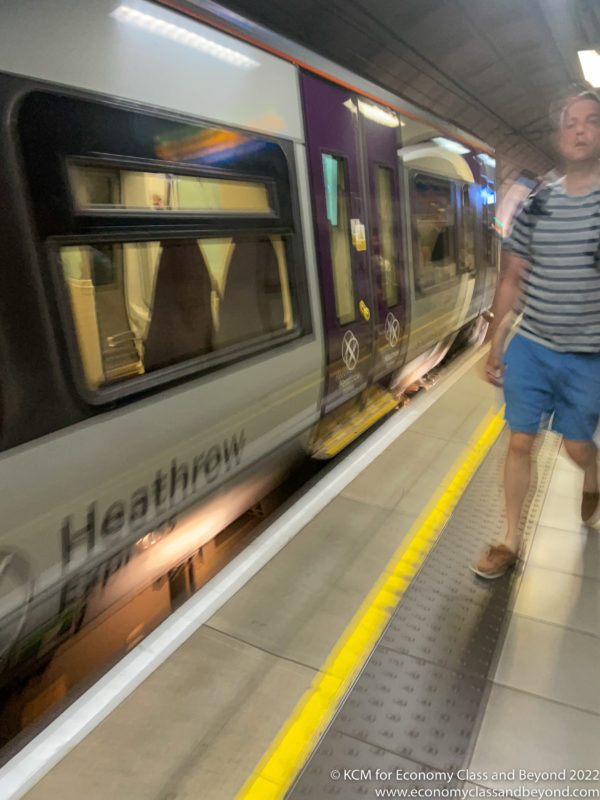 a man walking next to a train
