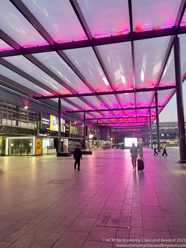 a large covered walkway with pink lights