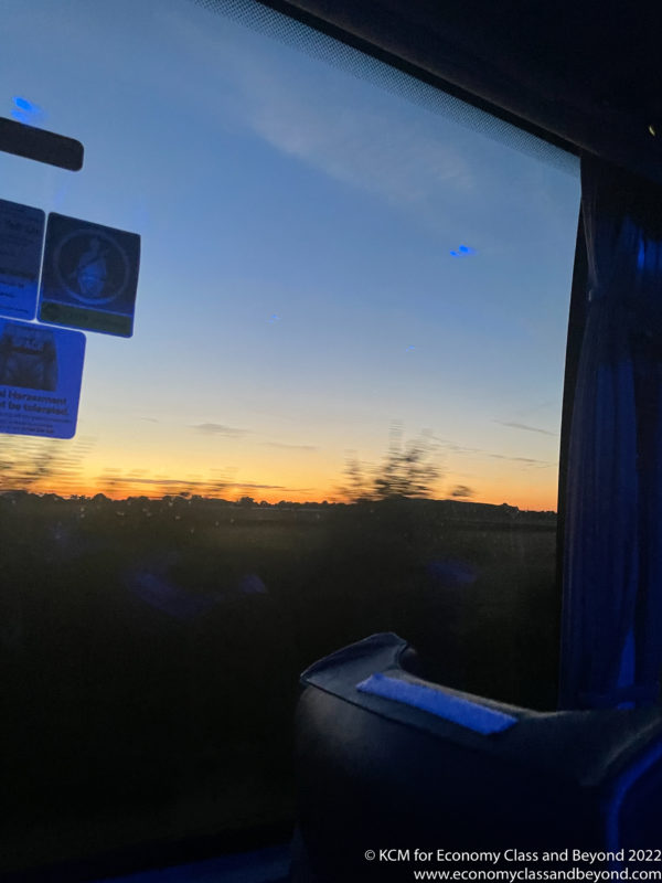 a view of a sunset from a bus window