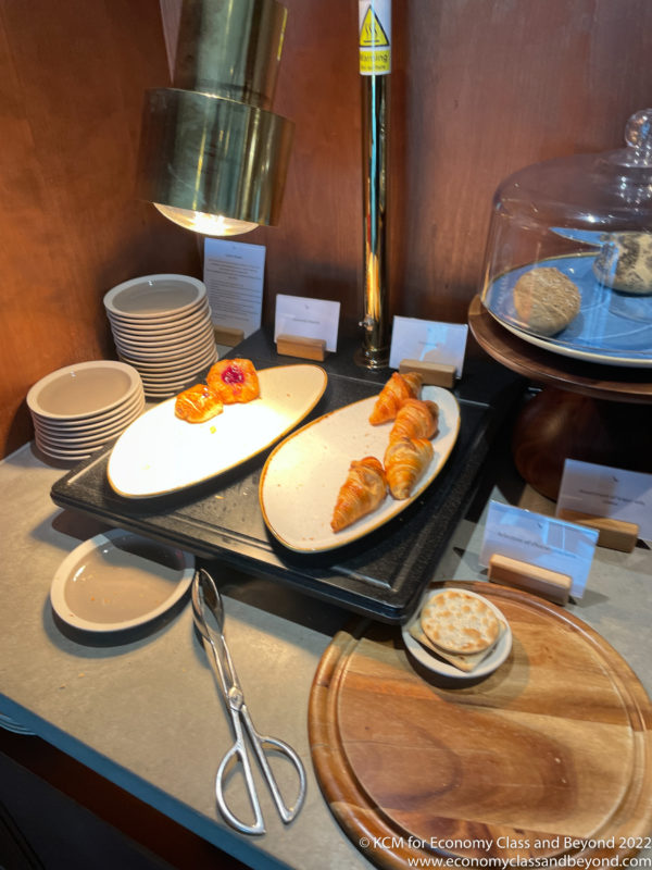 a tray of pastries and plates on a table