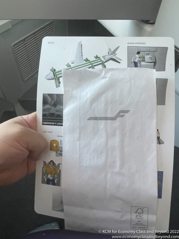 a hand holding a paper with an image on it
