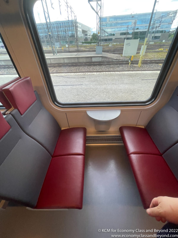 a red and black seats in a train